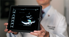Doctor holding a tablet showing an ultrasound image