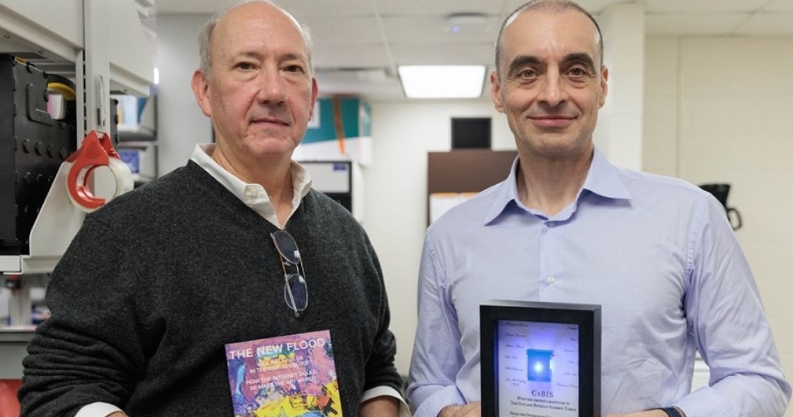 Timothy McCaffrey (l) and Ulvi M. Kasimov tour Dr. McCaffery’s lab where he is developing a RNA-based diagnostic device.
