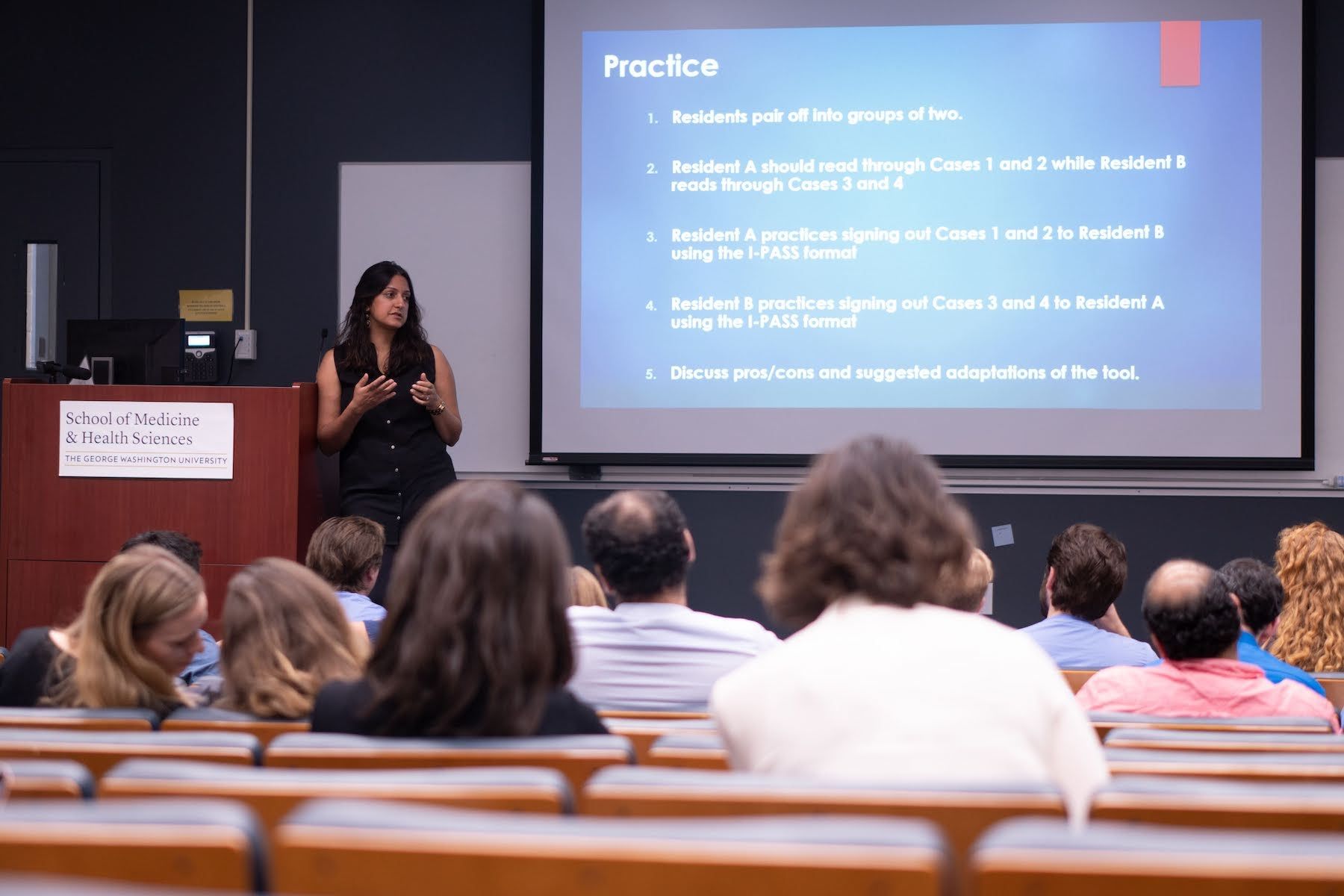A faculty member giving a presentation in a lecture hall