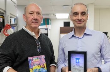 Timothy McCaffrey (l) and Ulvi M. Kasimov tour Dr. McCaffery’s lab where he is developing a RNA-based diagnostic device.